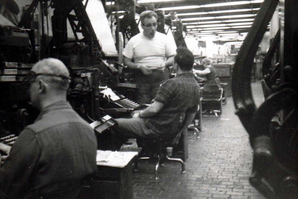 Bank of Linotypes, with a female operator in the background